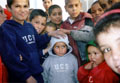 young orphans wearing new clothing donated by Tesco